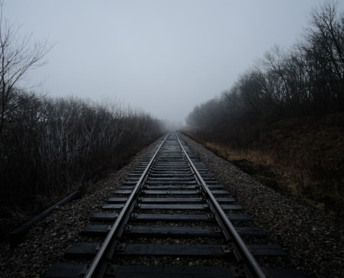 black railway covered with fog
