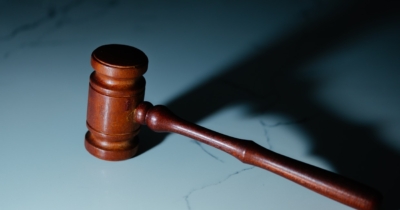 a wooden judge's hammer sitting on top of a table