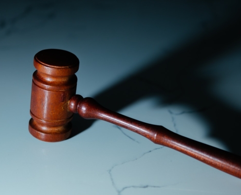 a wooden judge's hammer sitting on top of a table